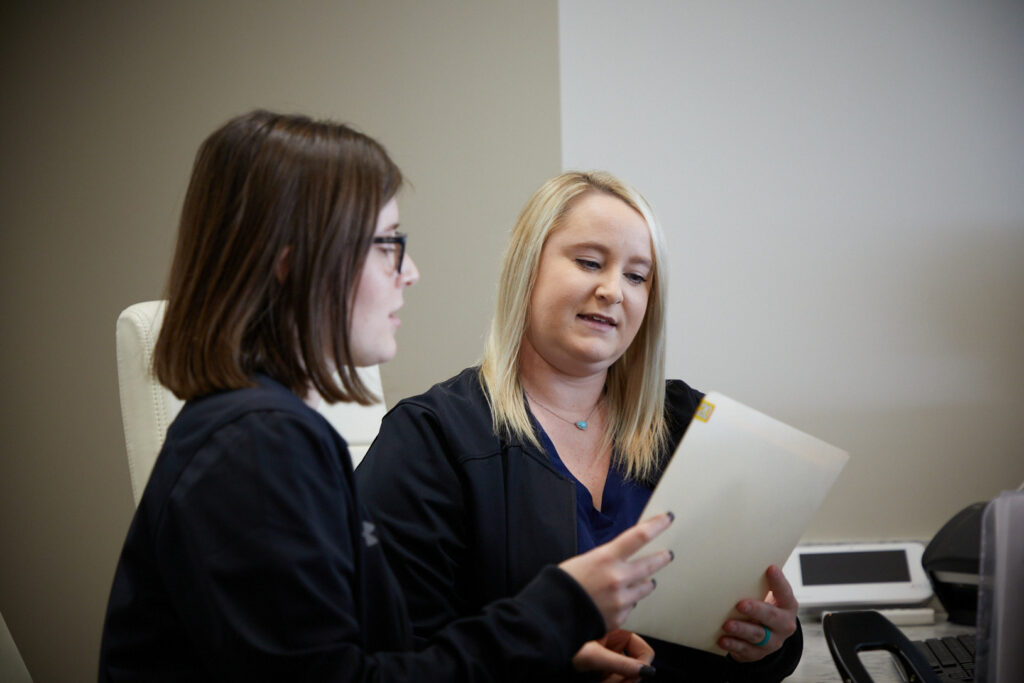 The staff at Greenville Oral Surgery looking over patient files