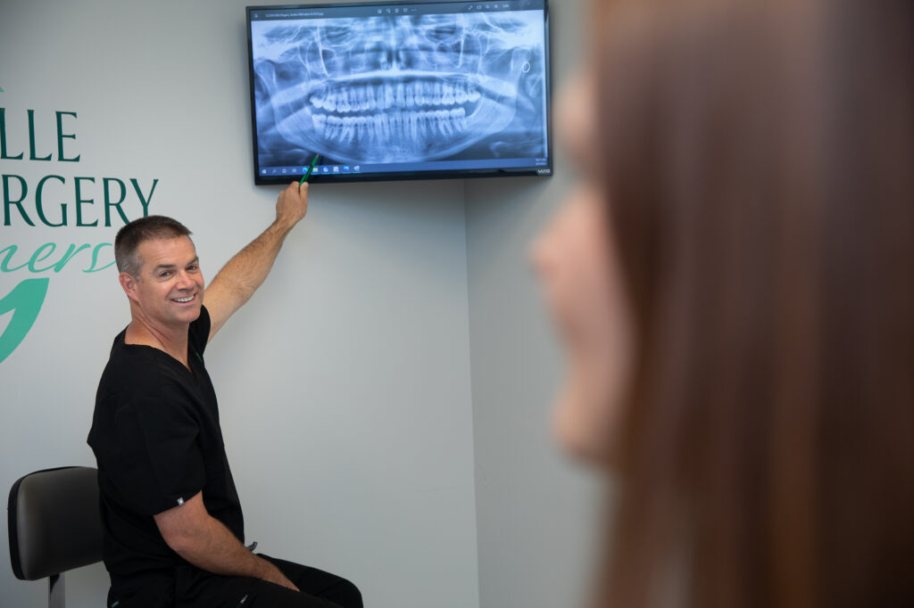 Dr. Derek Dunlap helping an oral surgery patient at Greenville Oral Surgery