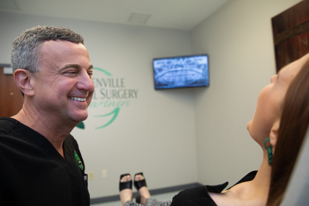 Dr. J. Lee Moore helping an oral surgery patient at Greenville Oral Surgery